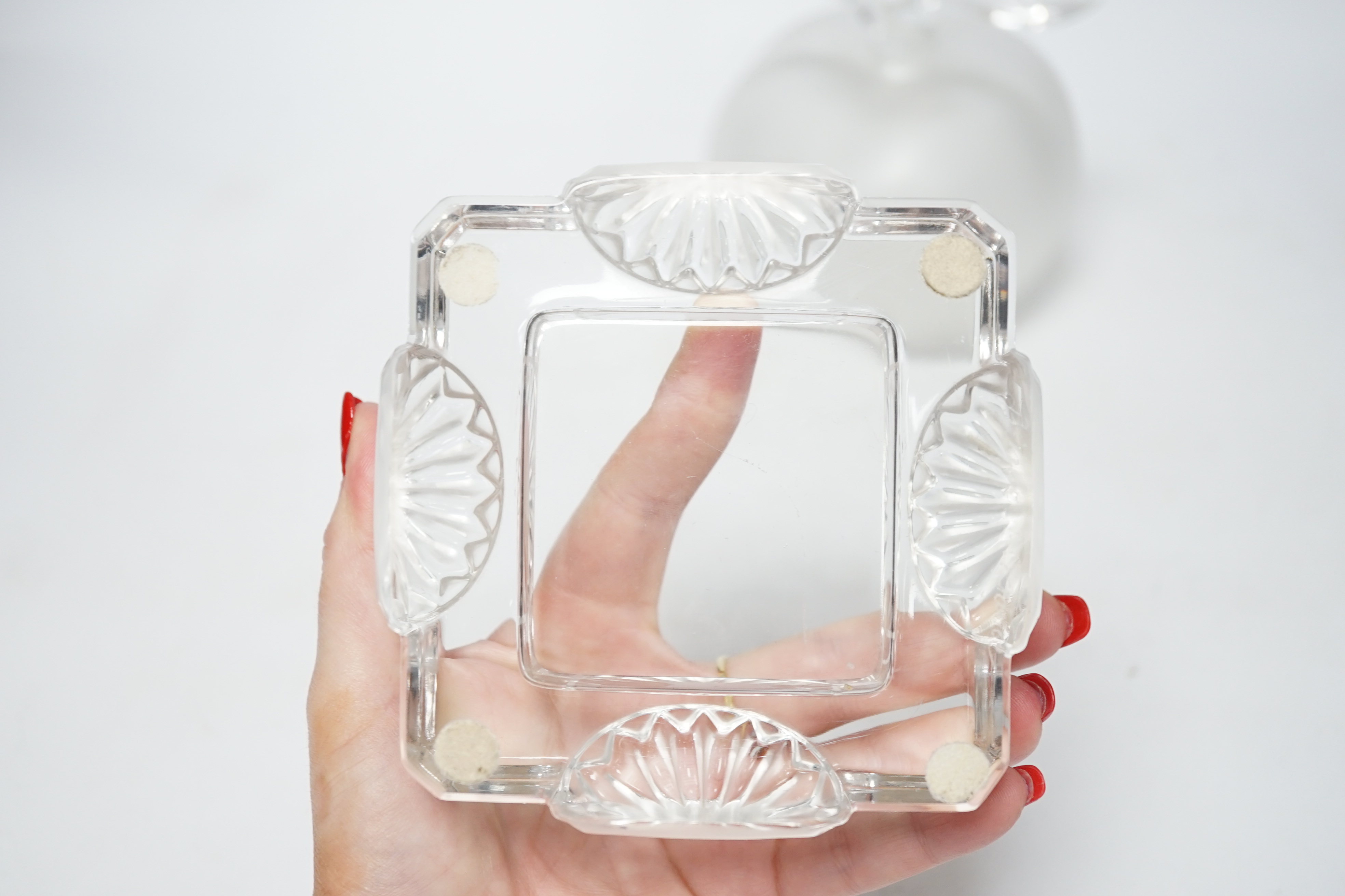 A Lalique apple shaped perfume bottle and leaf stopper together with a square ashtray, both with signed engraving to base, perfume bottle 14cm high